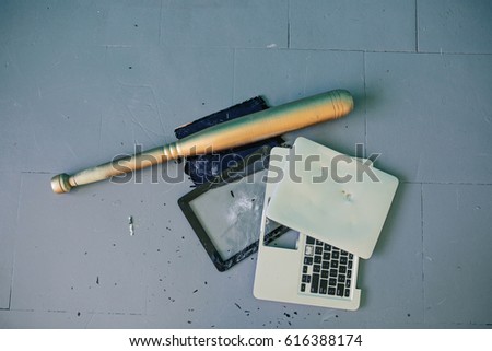Baseball bat and broken laptop