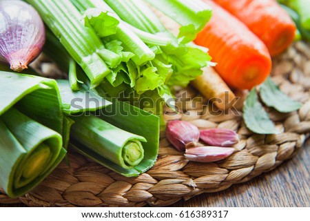 Fresh ingredients for veggie stock : carrots, celery, leeks, onion, carrots, parsnip, parsley, garlic, bay leaves, peppercorns, chili. Spring, summer products, seasonal vegetables to make your soup.