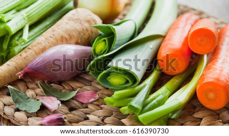 Fresh ingredients for veggie stock: carrots, celery, leeks, onion, carrots, parsnip, parsley, garlic. Seasonal vegetables to make your soup. The best from garden market and farm shop.