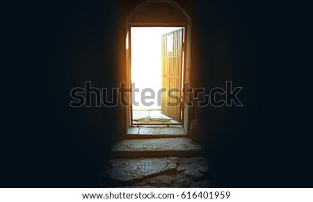 
Light entering through open door to a dark empty room Royalty-Free Stock Photo #616401959