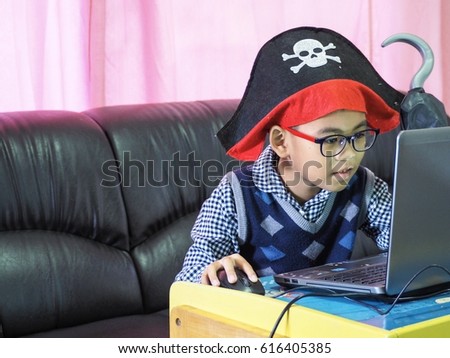 The pirate is learning from the laptop.