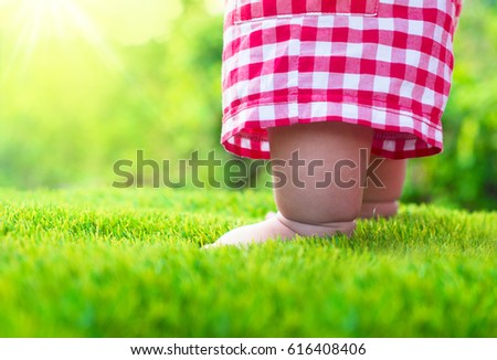 Baby standing on green grass with sunlight background,Startup concept