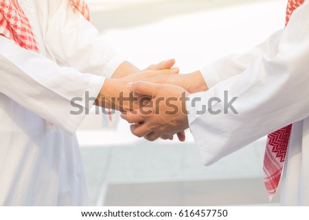 Arab Business handshake and business people on city background Royalty-Free Stock Photo #616457750