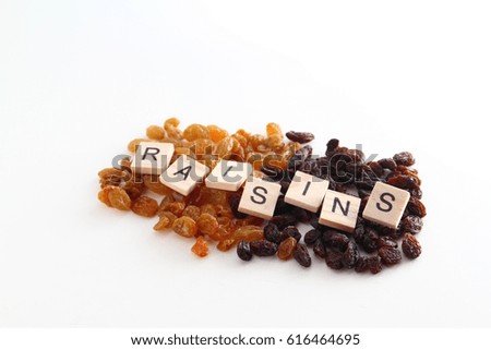 Raisins background / A raisin is a dried grape. Raisins are produced in many regions of the world and may be eaten raw or used in cooking, baking, and brewing.