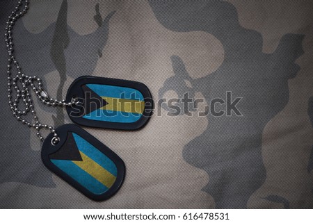 army blank, dog tag with flag of bahamas on the khaki texture background. military concept