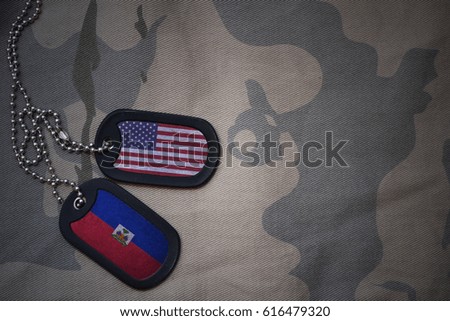 army blank, dog tag with flag of united states of america and haiti on the khaki texture background. military concept