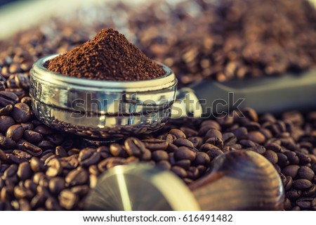 Coffee beans and portafilter.  Royalty-Free Stock Photo #616491482