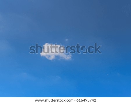 Alone small clouds floating in blue sky