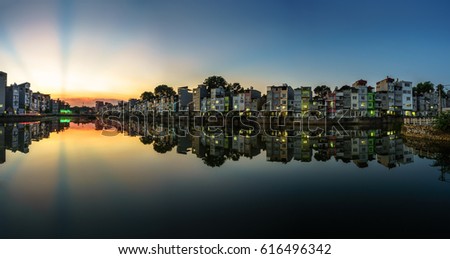 Hanoi cityscape at sunset. Resident buildings by Tien Bien lake, Gia Lam district