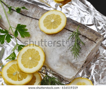 Raw fish with spices and lemon ready for baking.