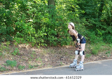 sporty girl on roller skates in the park