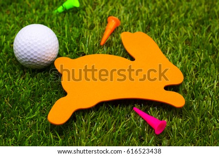 Golf Easter Holiday with Rabbit sign with golf ball and tee are on green course. Happy Easter for golfer concept.