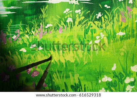 A fragment of the picture. artist's brush to apply paint to a picture paints a grass and flowers 