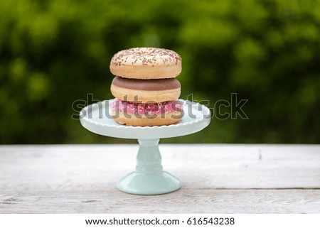 Stylish picture in bright colors of Delicious donuts on a wooden table.
