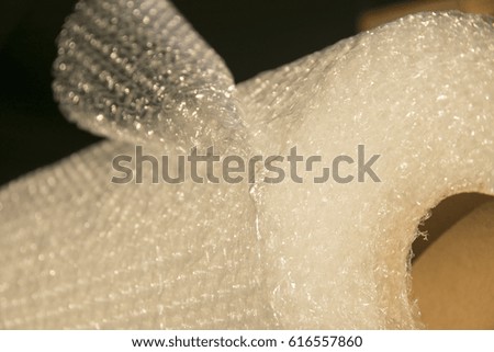 Bubble wrap used for packaging fragile items on grey background