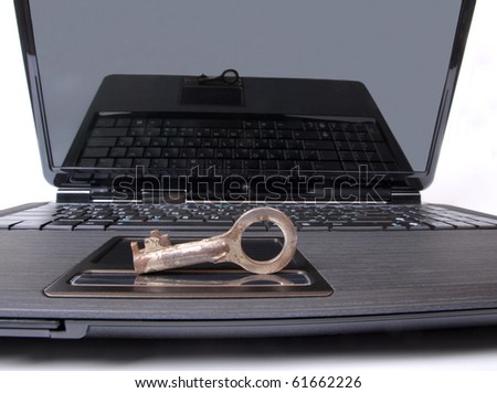 Color photo of a laptop keyboard and metal key