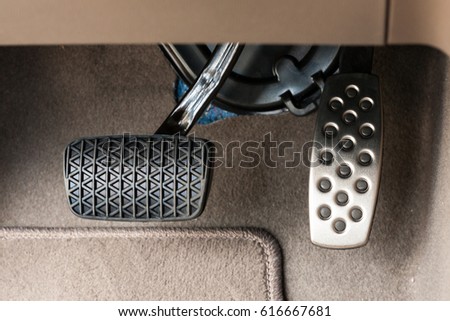 Foot pedals are levers that are activated by the driver's feet to control certain aspects of the vehicle's operation brake pedal/Car accelerator pedal and brake pedal/Car controls  Royalty-Free Stock Photo #616667681