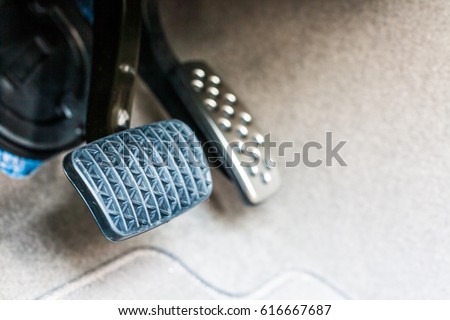 Foot pedals are levers that are activated by the driver's feet to control certain aspects of the vehicle's operation brake pedal/Car accelerator pedal and brake pedal/Car controls  Royalty-Free Stock Photo #616667687