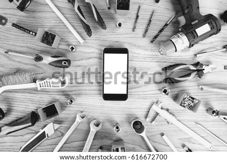 Smartphone and construction tools with blank for sign, top view, flat lay. Tools sailing and workers concept.
