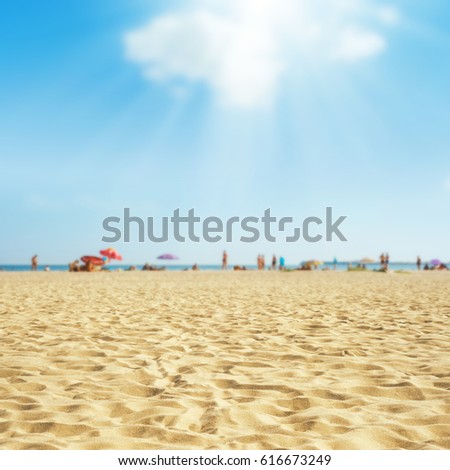 sand on the beach under clouds in blue sky. soft focus on bottom of picture