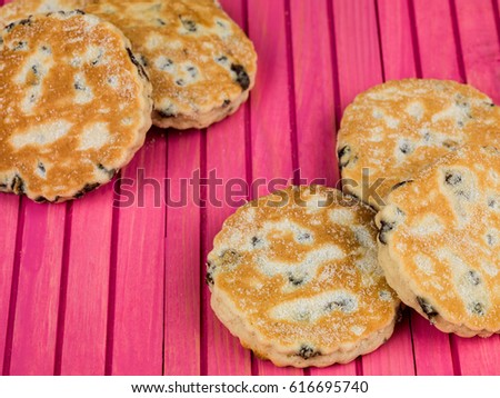 Baked Fruit Welsh Cakes Against a Pink Background