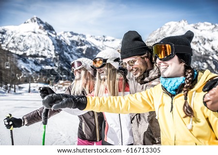Group of friends having fun on the snow