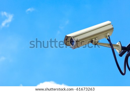 Close up of white security camera and white sky Royalty-Free Stock Photo #61673263