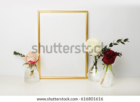 gold picture frame with decorations. Mock up for your photo or text Place your work, print art, roses in vase