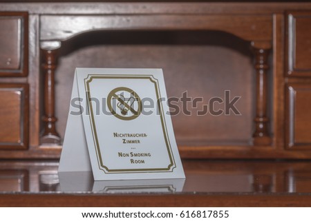 No smoking sign on wood table in the room at hotel.