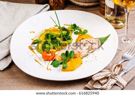 grilled salmon steak on a round white plate