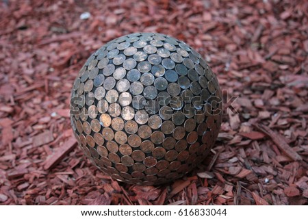 Sphere covered in old pennies