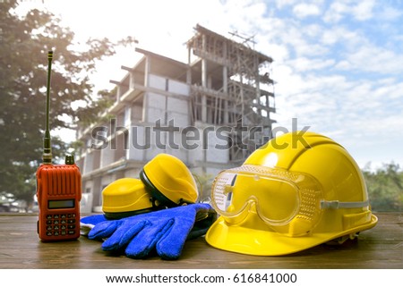 safety concept, Standard construction safety equipment on wood with construction background
