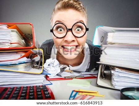 Workaholism mental insanity weird job work company concept. Insane office woman at work. Mad secretary making silly expression lurking through her desk. Royalty-Free Stock Photo #616843913
