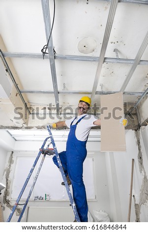 Happy Worker Installing Drywalls