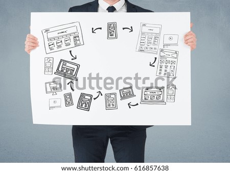 Digital composite of Businessman holding card with business graphics drawings
