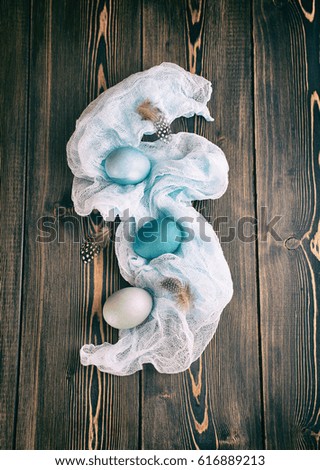 Blue and gray Easter eggs wrapped with vintage fabric, toned picture. Rustic style.