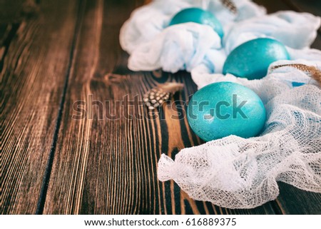 Blue Easter eggs wrapped with vintage fabric, toned picture. Vintage style, copy space for text.