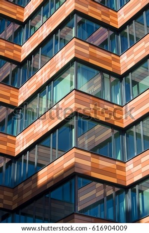 Abstract architecture, fragment of modern urban geometry. Walls made of steel and glass. Business building/ office center Royalty-Free Stock Photo #616904009