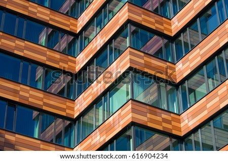 Abstract architecture, fragment of modern urban geometry. Walls made of steel and glass. Business building/ office center Royalty-Free Stock Photo #616904234