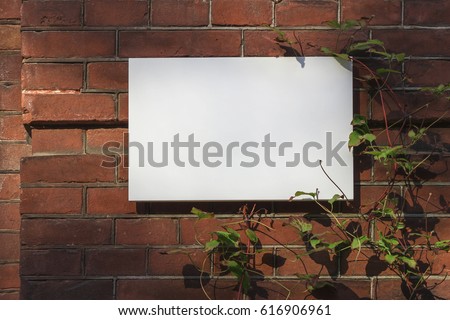 Marble white blank signboard on red brick wall for text or logo mockup.