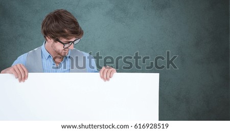 Digital composite of Smiling man looking at blank billboard against gray background