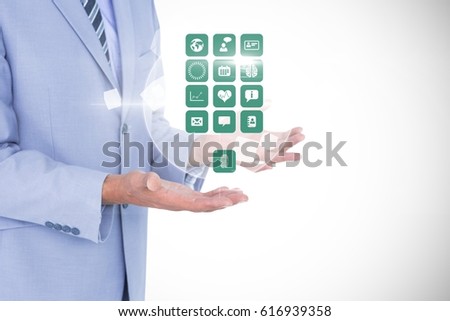 Digital composite of Digitally generated image of businessman holding various icons against white background