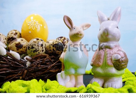 Funny Bunnies, and Easter quail eggs in the basket - Easter decoration
