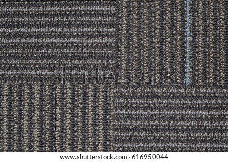 Section of line patterned carpet showing four quarters with the pattern going in a clockwise direction.