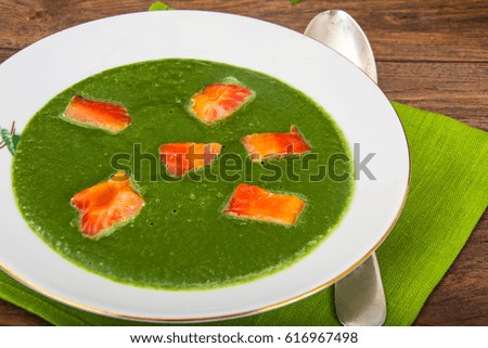 Soup puree from spinach with salmon. Studio Photo