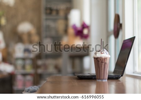 Ice Chocolate, Whip Cream, Chocolate Chip Cookie, Chopstick in Plastic Transparent Cup with Laptop Computer Notebook on Table. Set as Copy Space for Text. Idea Concept for Relax Time.