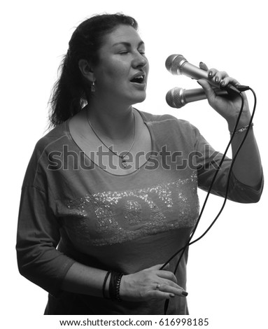 Black and white portrait of a female singer with a microphone in her hands