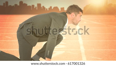 Digital composite of Business man at start line against orange flare with skyline