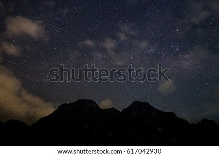 High ISO photo of fainted milky way as cloud cover the sky with a great mountain silhouette at Sam Roi Yot National Park, Prachuap Khiri Khan, Thailand