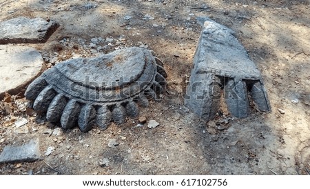 Ancient 13th century jain temple decorative elements made by carving rock stone sculpture with design texture broken and fallen on ground with dirt dust at Budhpur Purulia West Bengal India